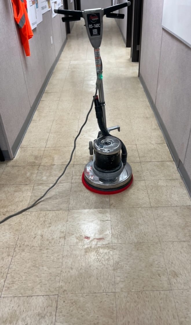 Same corridor floor before finishing, dull with floor machine mid-service